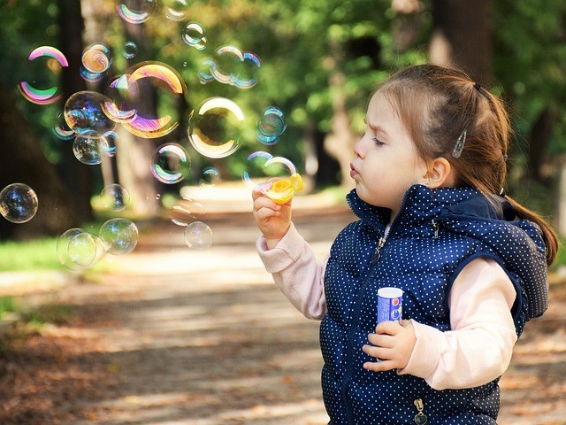 girl blow bubbles